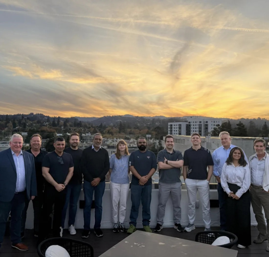The ePass team gathered on a rooftop at sunset